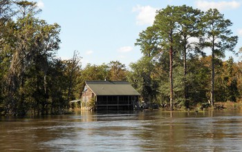 Floodwaters around a house.